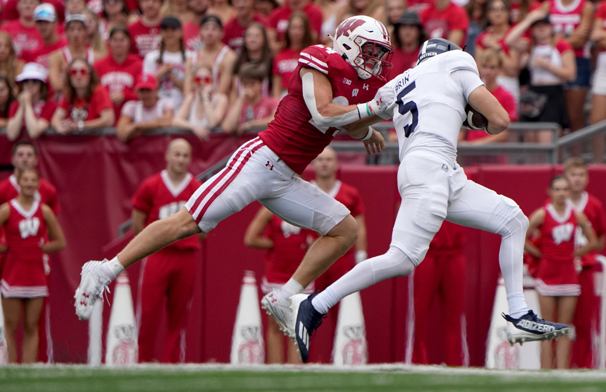 Sep 16, 2023; Madison, Wisconsin, USA; Wisconsin Badgers safety Hunter Wohler (24) sacks Georgia Southern Eagles quarterback Davis Brin (5) during the second quarter at Camp Randall Stadium. Mandatory Credit: Mark Hoffman-USA TODAY Sports